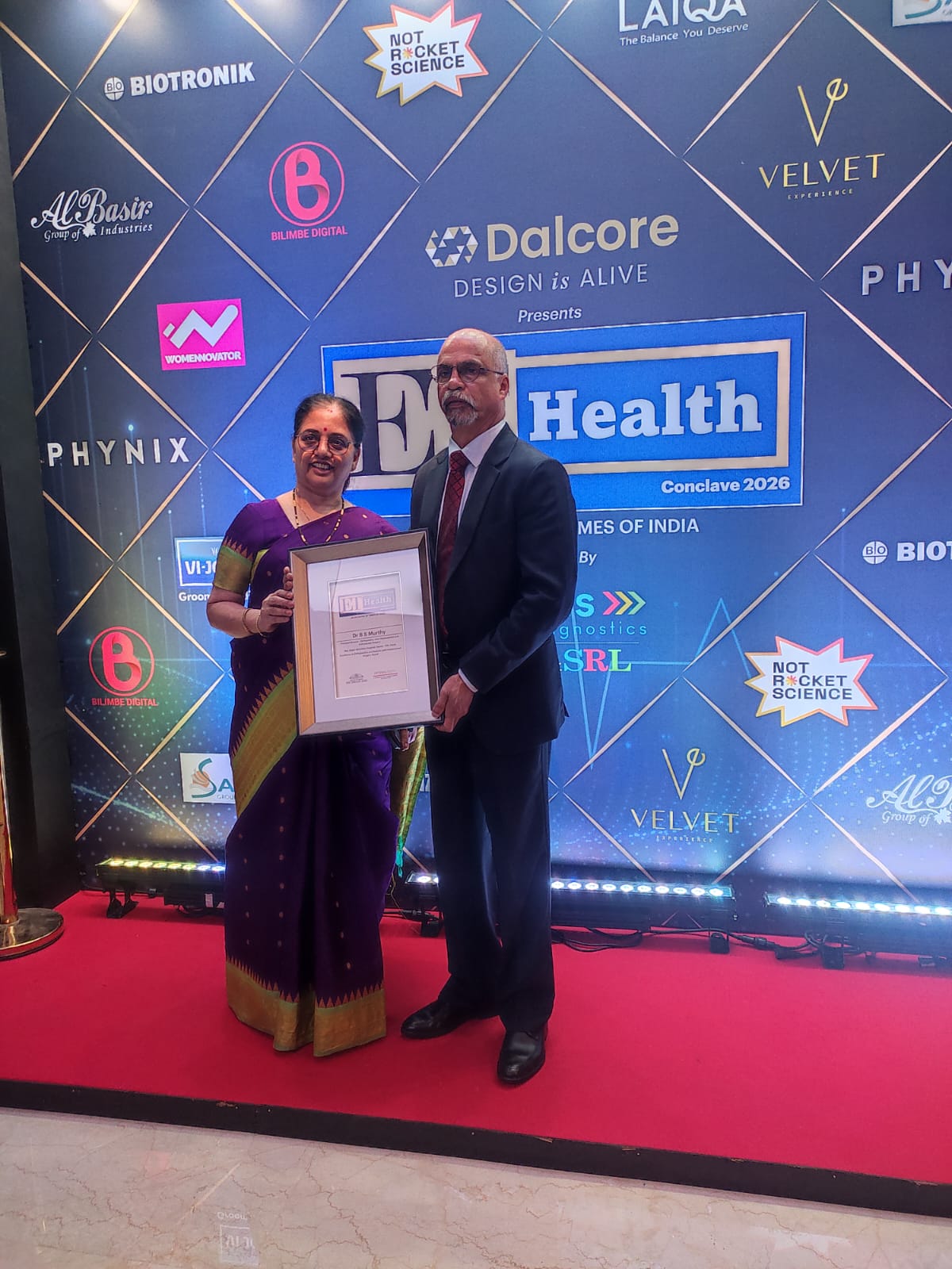 Dr B S Murthy with his wife holding the Excellence in Orthopedics award plaque at ET Health Conclave 2026