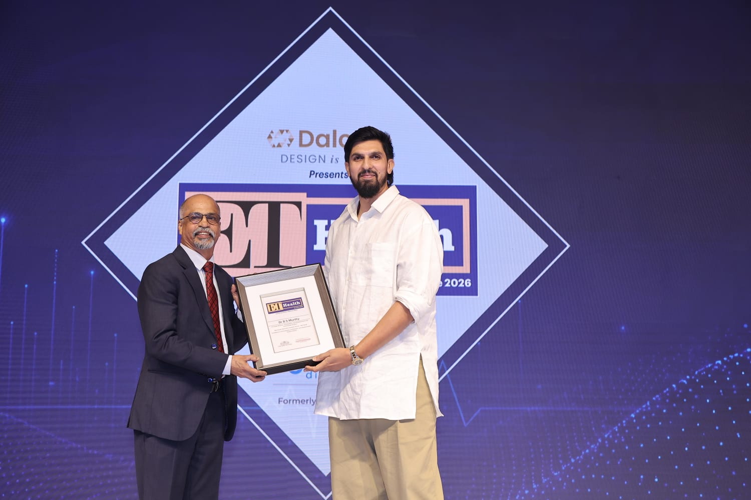 Dr B S Murthy receiving the Excellence in Orthopedics award from cricketer Ishan Sharma at ET Health Conclave 2026